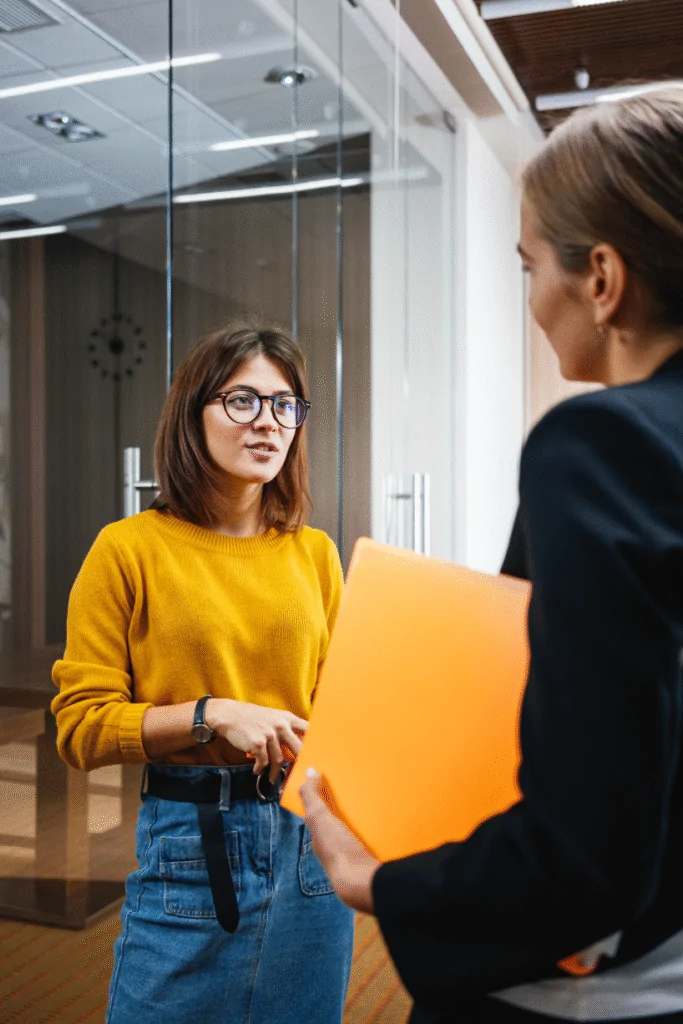 Two Business Women Having a Conversation in The Office
